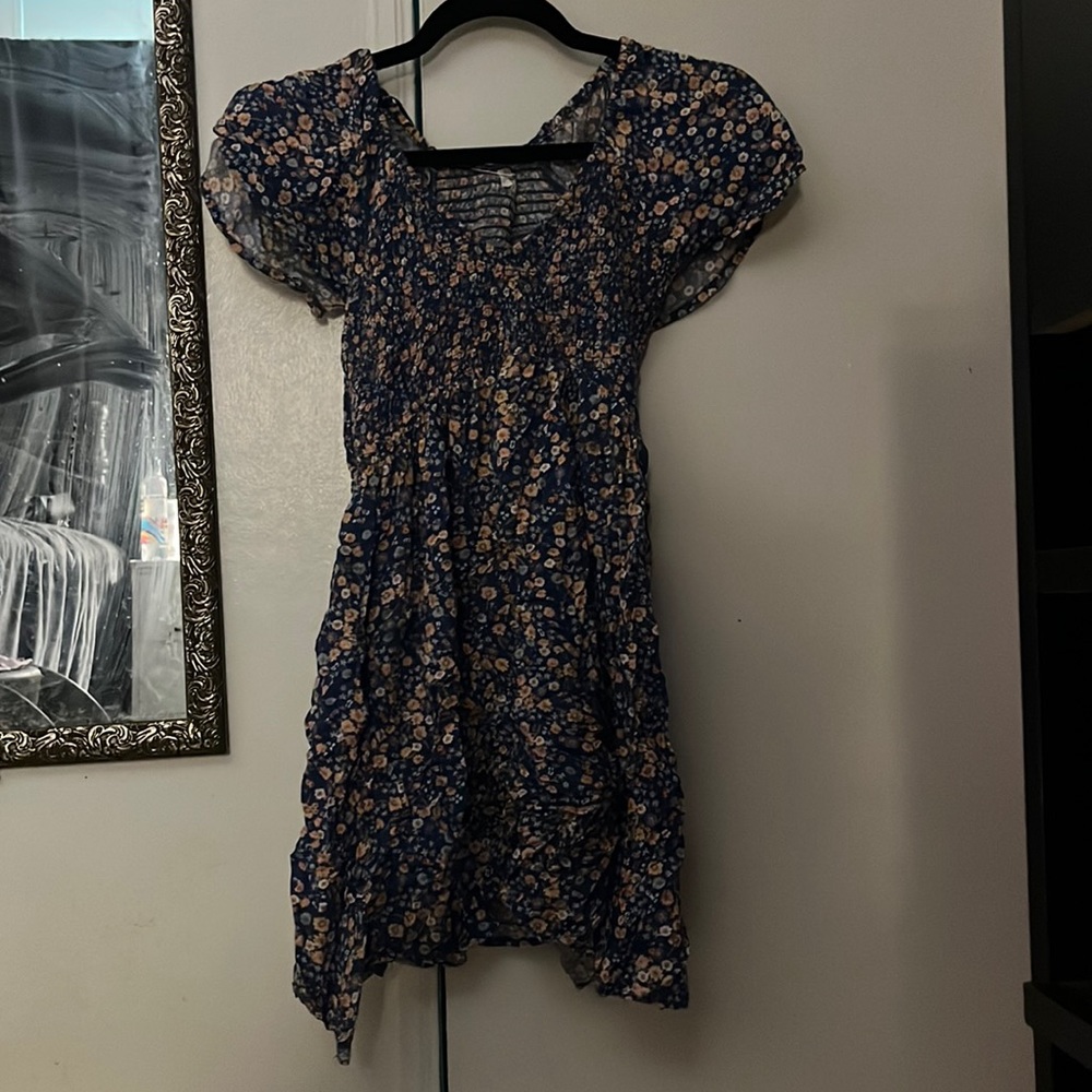 a cute summer dress. is a deep navy blue color with pink and white floral print.
